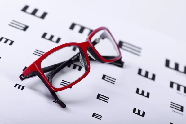 Eyeglasses and eye chart — Stock Photo, Image