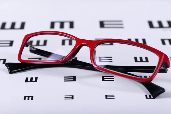 Eyeglasses and eye chart — Stock Photo, Image