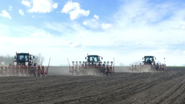 Tractors and seeders sowing field — Stock Video