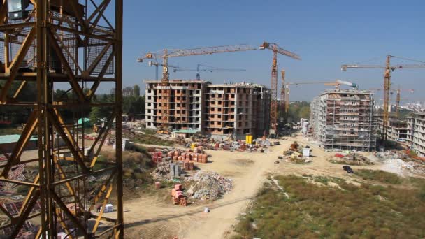 Working cranes near unfinished houses — Stock Video