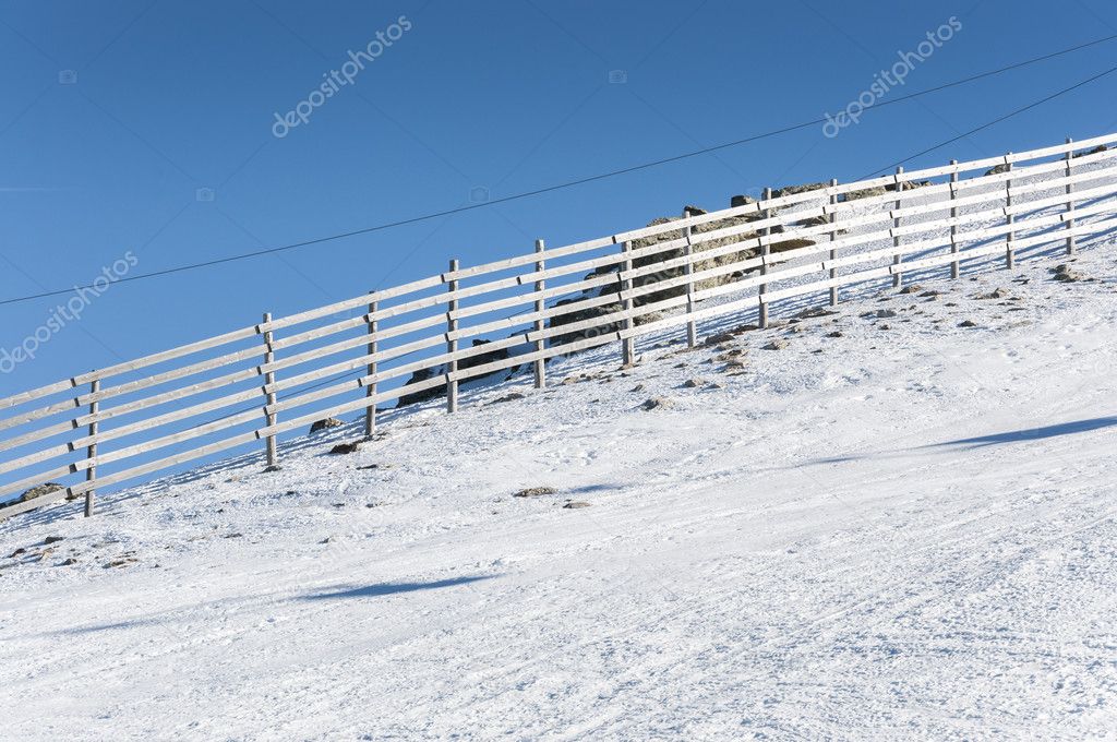 Wooden fence on the snow