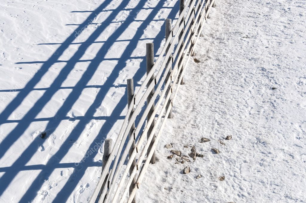 Wooden fence on the snow