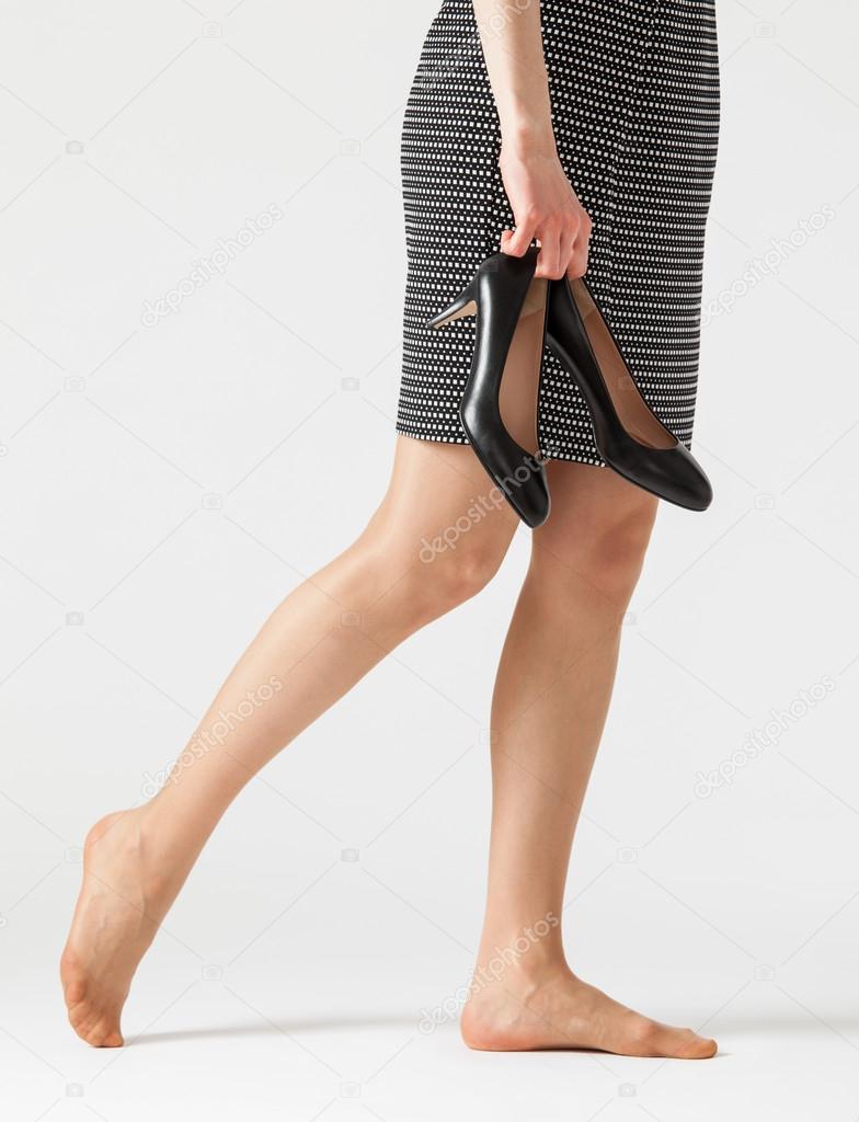 Young woman holding her shoes Stock Photo by ©zestmarina 101769586