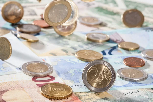 Many euro banknotes and coins — Stock Photo, Image