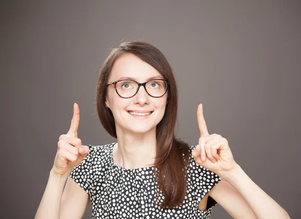 Smiling young woman indicating  up — Stock Photo, Image