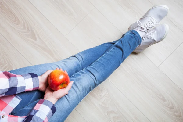 Kvinnan räcker anläggning moget rött äpple — Stockfoto