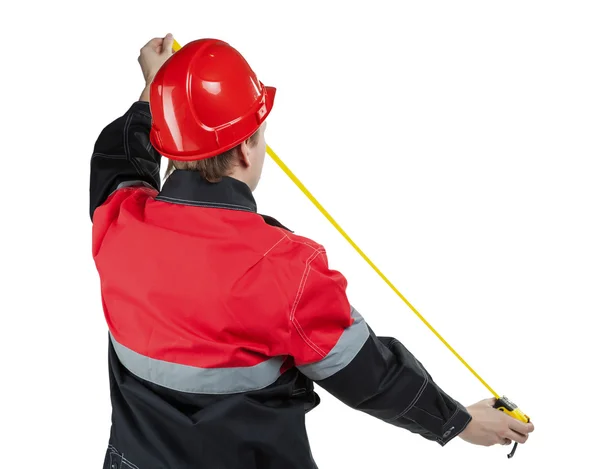 Builder in uniform with a tape-line — Stock Photo, Image