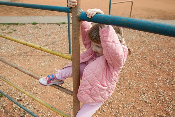 Aktiivinen pieni tyttö leikkii ulkona — kuvapankkivalokuva