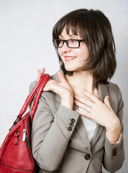 Beautiful young woman holding red bag — Stock Photo, Image