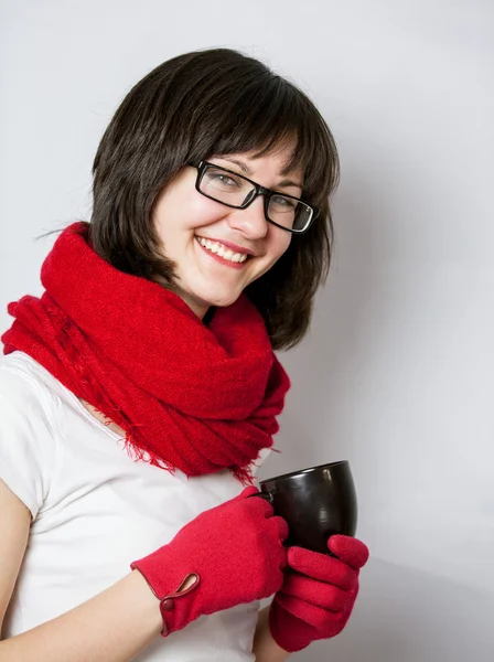 Smiling girl holding a black cup — Stock Photo, Image