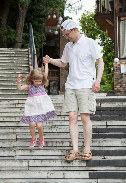 Little girl walking with her father — Stock Photo, Image