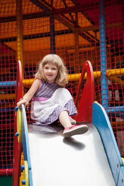 Little girl on children's slide — Stock Photo, Image