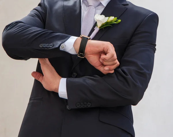 Bridegroom looks at his watch — Stock Photo, Image