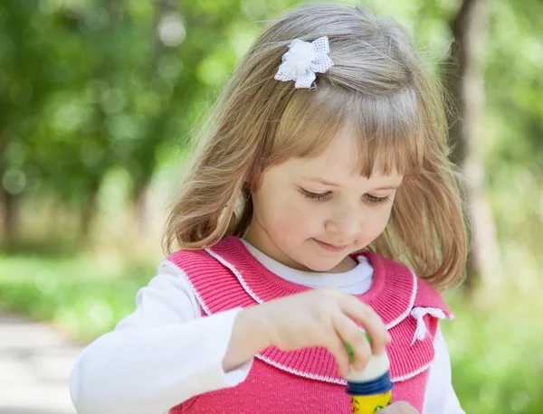 Little girl making soap bubbles — Stock Photo, Image