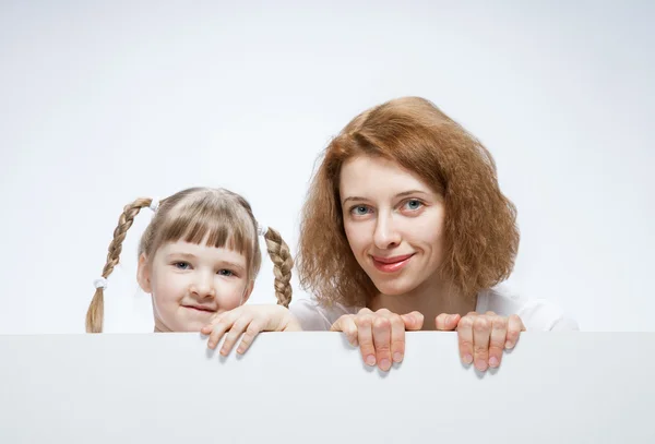 Mother and her daughter with white poster — Stock Photo, Image