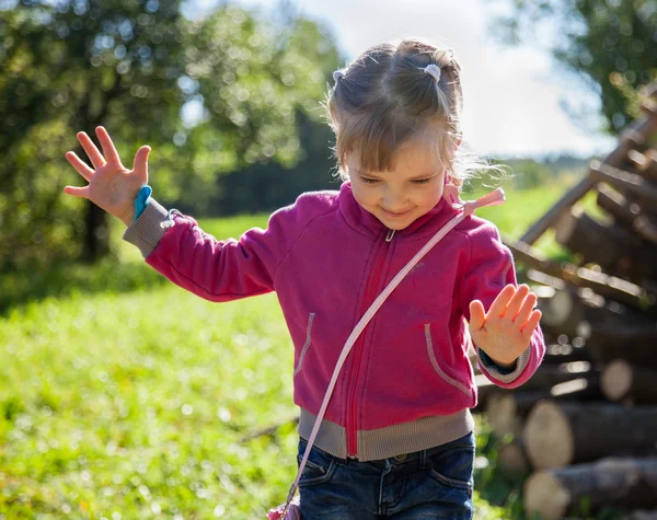 Smiling little girl keeps her balance — Stock Photo, Image
