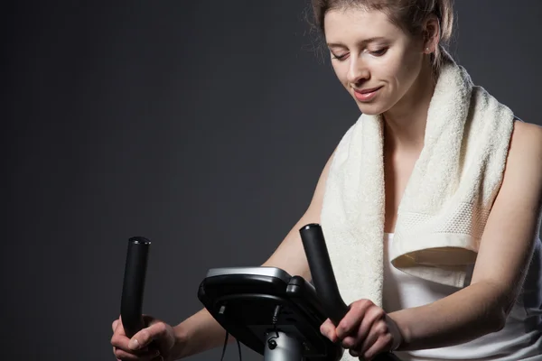 Woman on a training bicycle — Stock Photo, Image