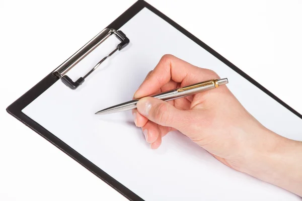 Hand writing with pen on clipboard — Stock Photo, Image