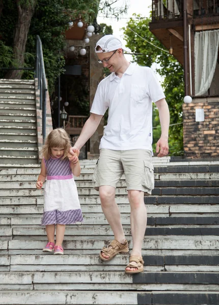Little girl walking with her father — Stock Photo, Image