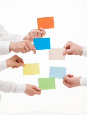 People holding colorful cards
