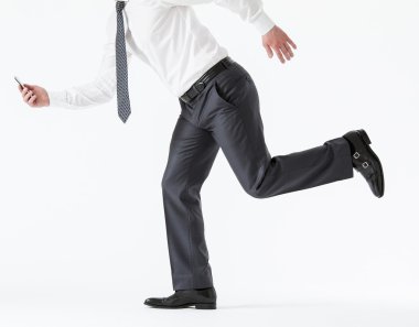 Businessman running with a cellphone
