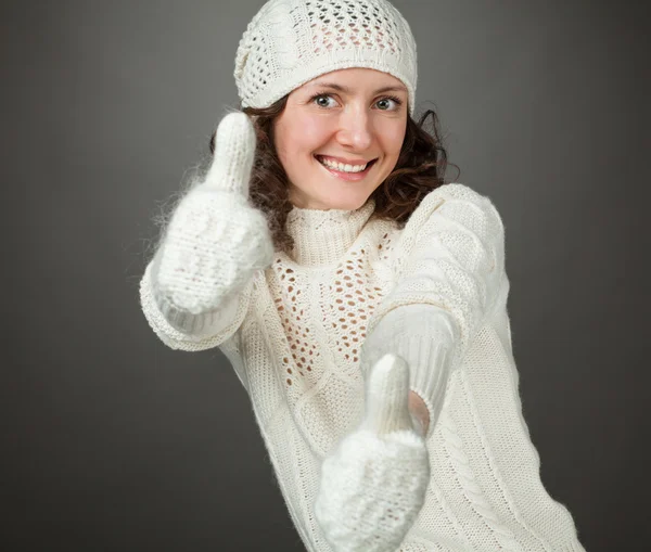 Smiling attractive girl showing thumbs up in mittens — Stock Photo, Image