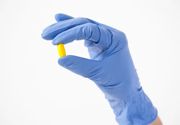 Doctor's hand in rubber glove holding a tablet — Stock Photo, Image