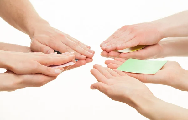 Several people hiding cards, one person showing a green card — Stock Photo, Image