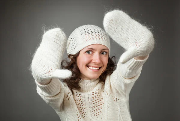 Portrait of happy young woman in white hat and mittens — Stock Photo, Image