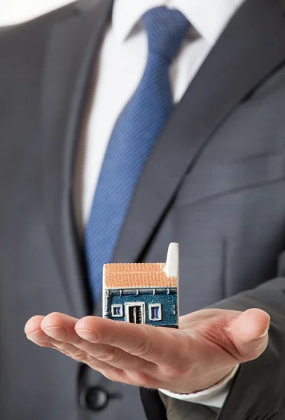 Unrecognizable businessman holding a toy house — Stock Photo, Image