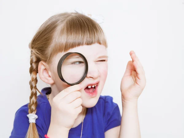 Funny little girl with loupe — Stock Photo, Image