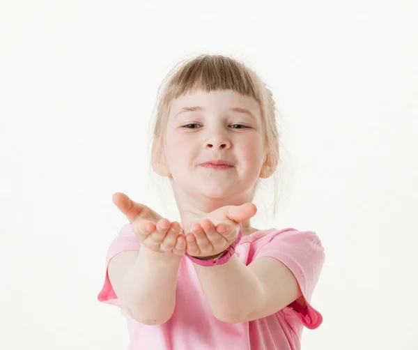 Glückliches kleines Mädchen, das seine Handflächen ausstreckt und etwas fängt — Stockfoto