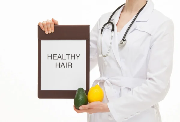 Doctor holding a clipboard and fresh fruits — Stok fotoğraf