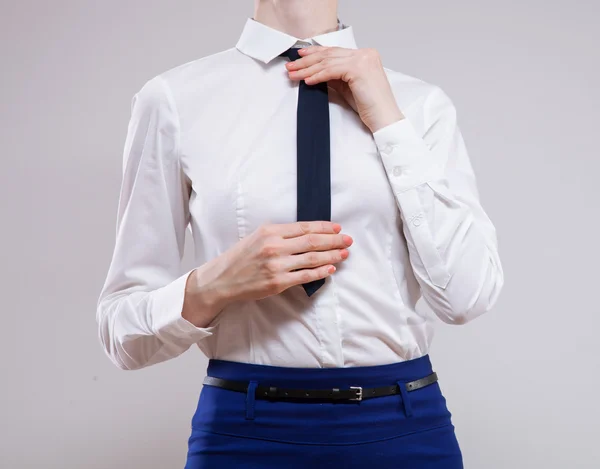 Businesswoman sets the necktie — Stock Photo, Image