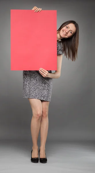 Woman holding red poster — Stock Photo, Image