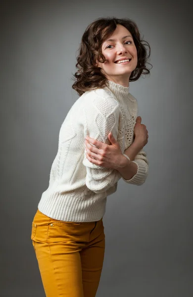 Happy young woman posing in a studio — Stock Photo, Image