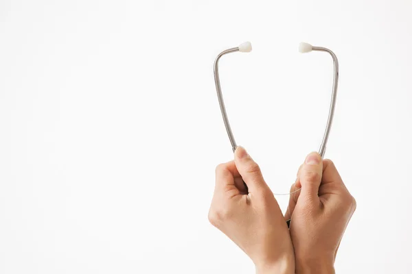 Hands holding a stethoscope — Stock Photo, Image