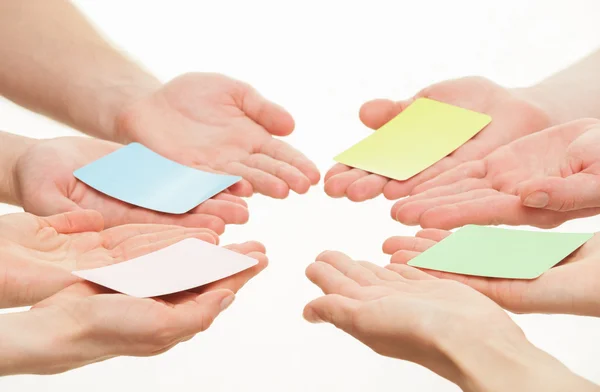 Hands reaching out paper cards — Stock Photo, Image