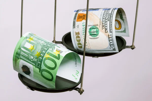 Dollar and euro banknotes on the scale — Stock Photo, Image