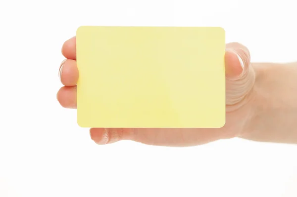 Female hand holding a yellow  paper card — Stock Photo, Image