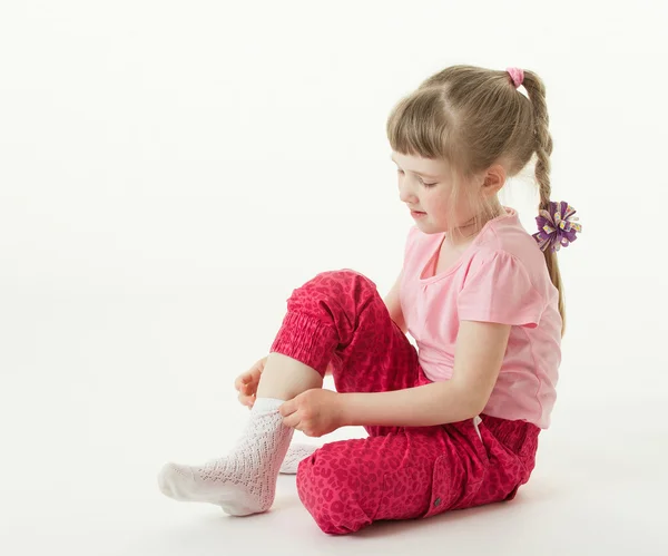 Girl trying on sock — Stock Photo, Image