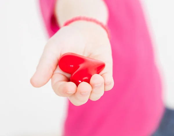 Onherkenbaar meisje houdt van een rood hart — Stockfoto