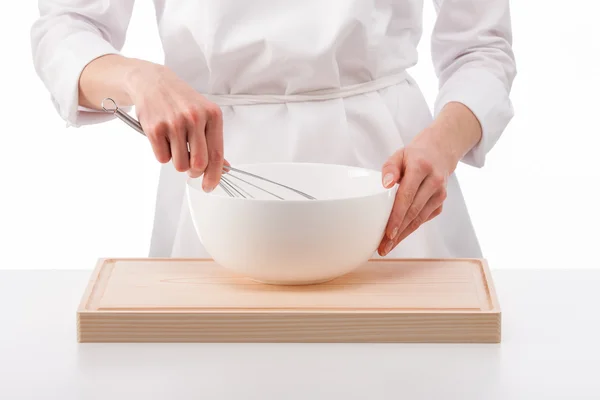 Woman cook whips something in a bowl — Stock Photo, Image