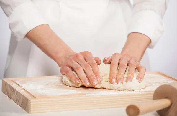 Female cook kneading dough — Stock Photo, Image