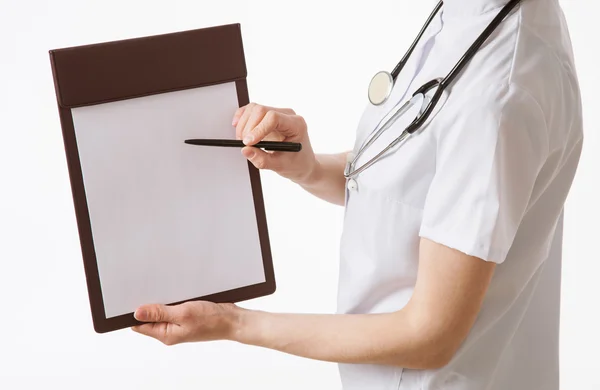 Doctor holding empty clipboard and a pen Stock Picture