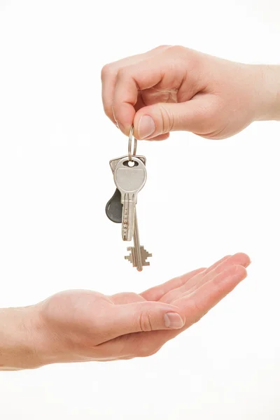 Man's hand giving a bunch of keys Stock Image