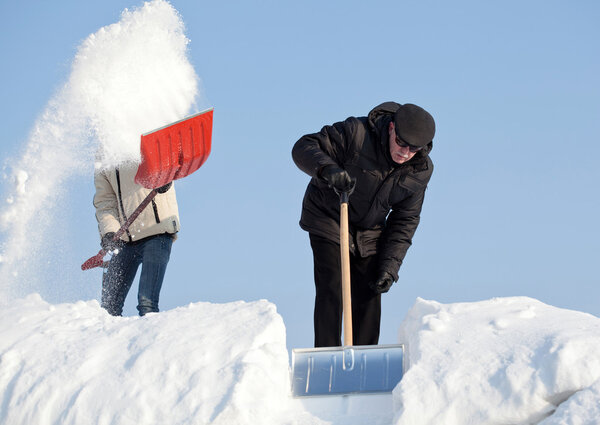 People shovelling snow