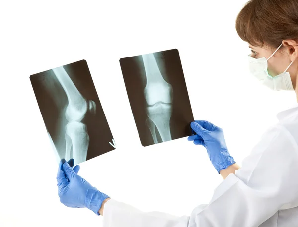 Doctor examining X-rays — Stock Photo, Image