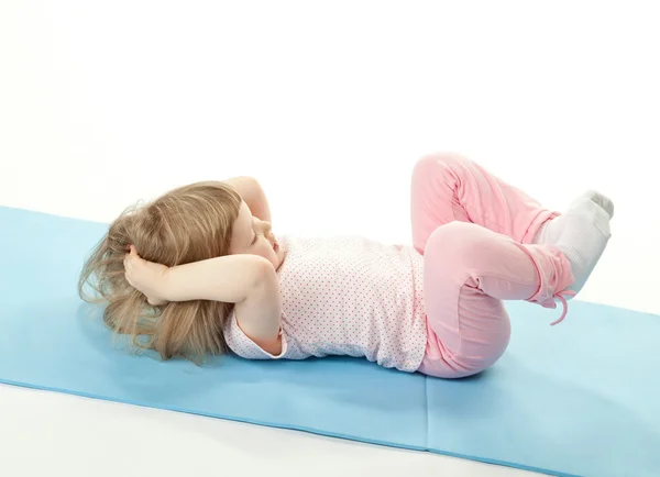 Little girl doing sport exercises — Stock Photo, Image