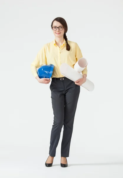 Businesswoman holding helmet and projects — Stock Photo, Image